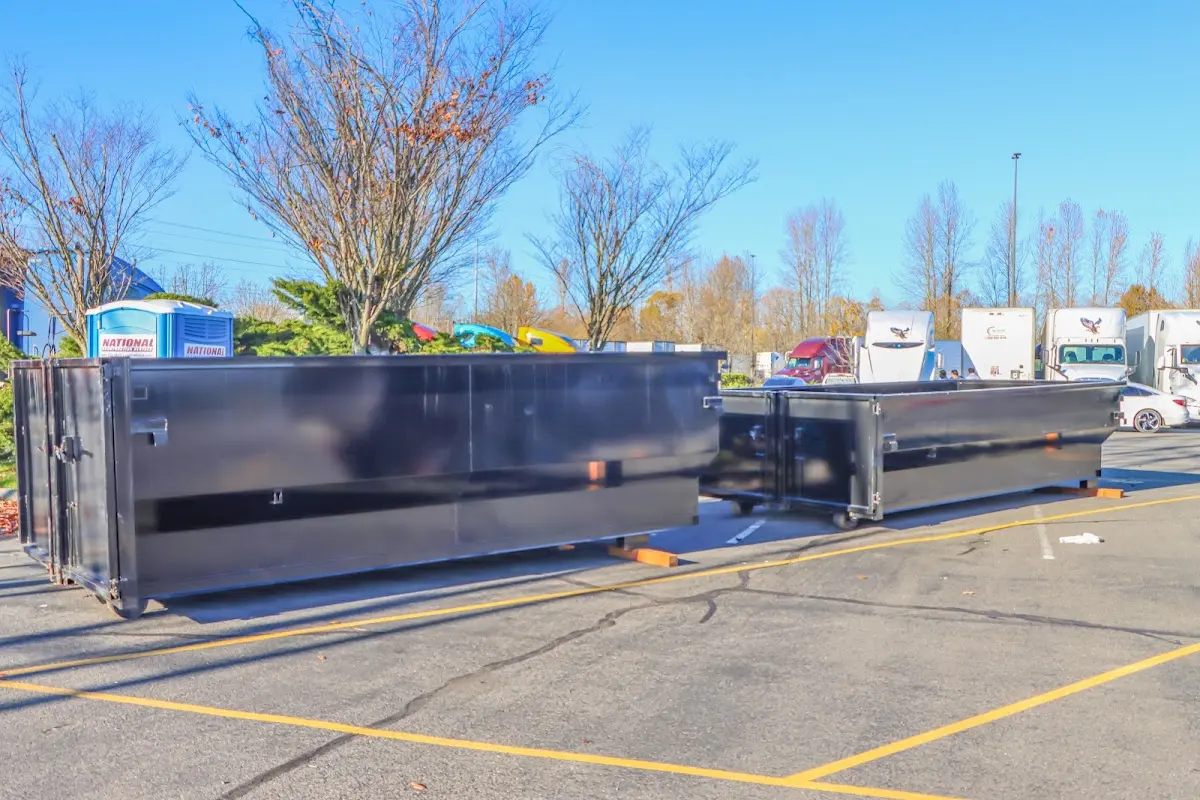 Professional dumpster rental service with roll-off container on residential driveway in Fort Hunt